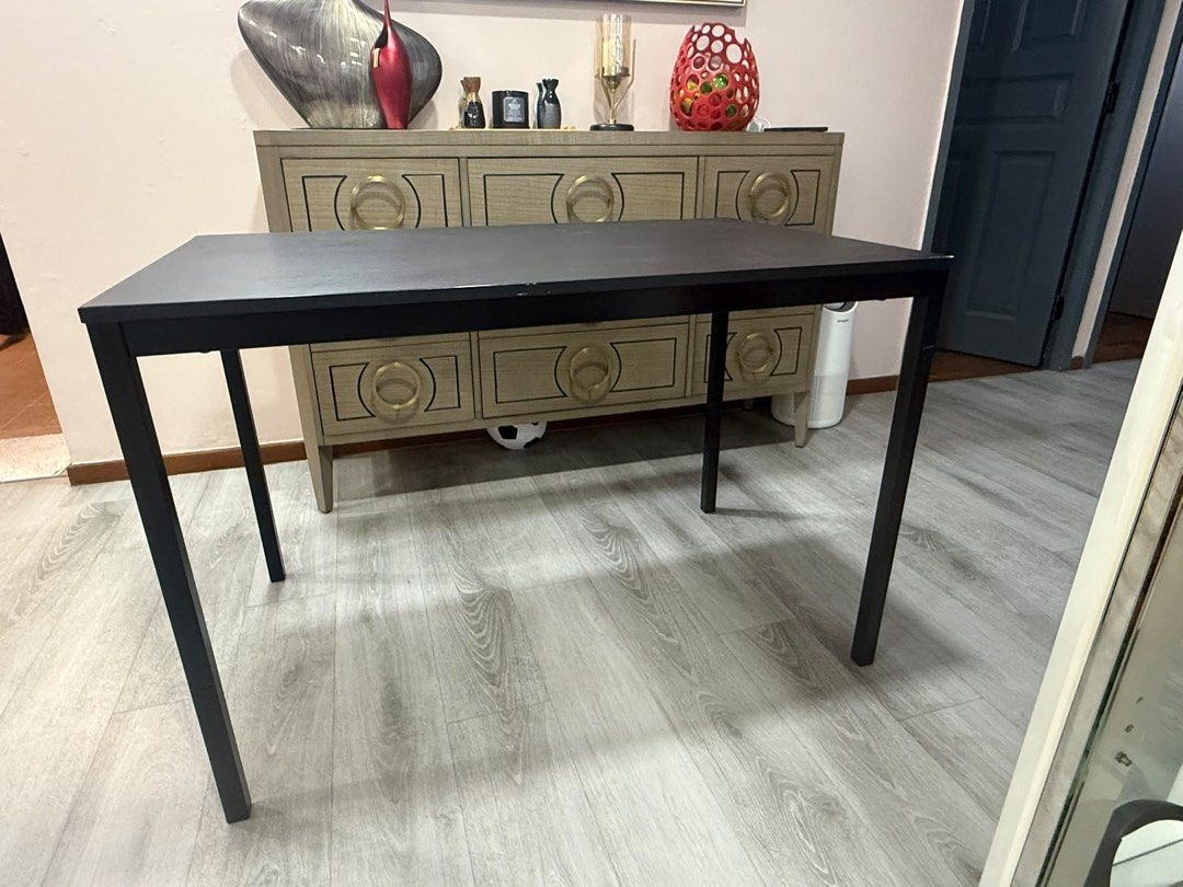 IKEA Table (Category: Tables & Sets) located in Singapore. Submitted by us3rfriendly (Listing ID 1451435813, Image 2). Description: - IKEA SANDSBERG Table - Colour: Black - Dimensions: 110cm x 67cmx74cm - Condition: Some wear and tear on edges (as pictured), still sturdy and functional. - Recently used as study table Price is negotiable. Able to trade with baby items as well such as 6-10 packets of Baby Wipes and 1 packet of Baby pampers. Expecti