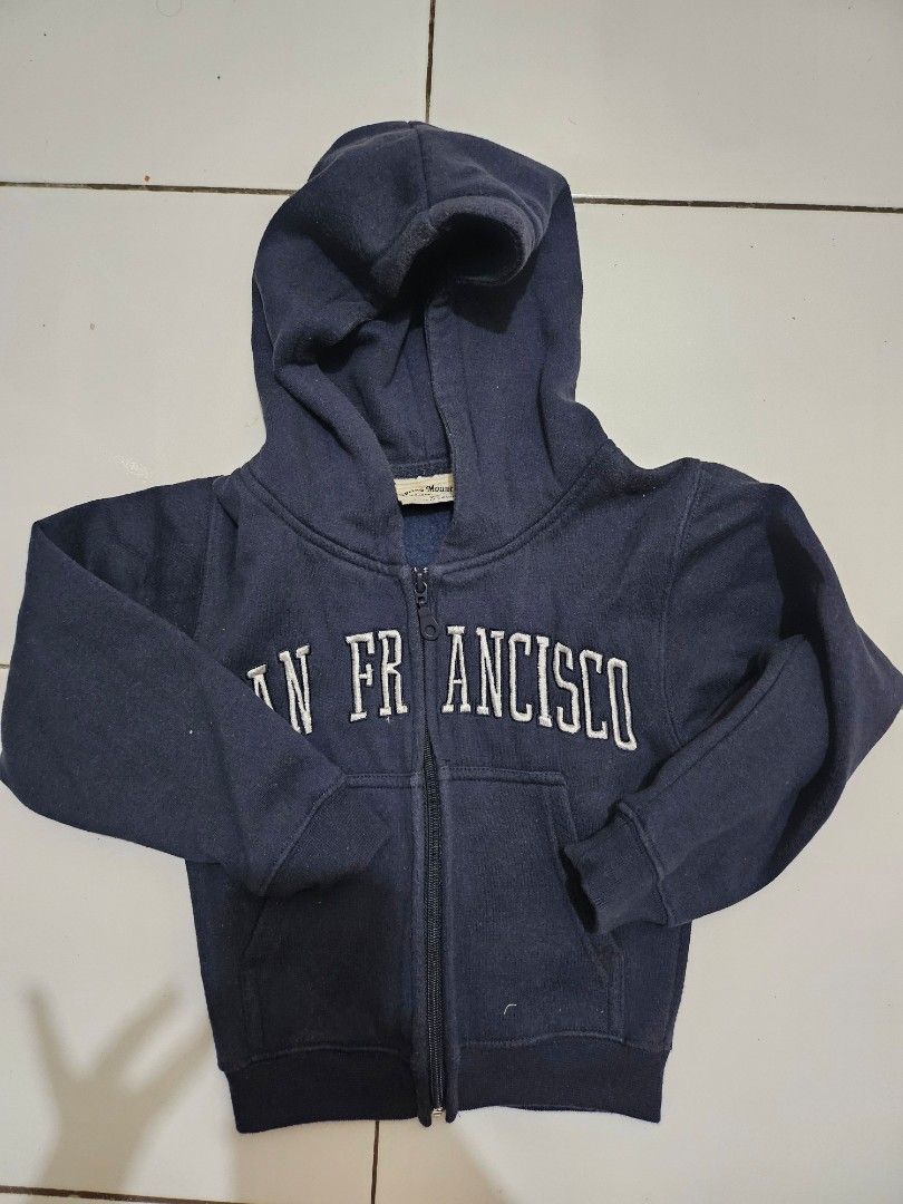 Kids Sweater & Jacket (Category: Babies & Kids Fashion) located in Mandaluyong City. Submitted by efril.pecson (Listing ID 1451433859, Image 2). Description: - Bundle of 2 kids' tops - Navy blue zip-up hoodie with 'San Francisco' graphic - Yellow long-sleeved sweatshirt with Mickey Mouse print - Perfect for casual wear - Ideal for kids who love graphics.