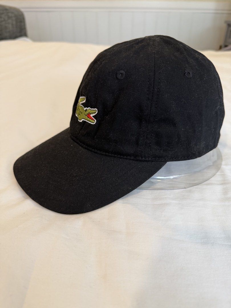 Lacoste Black Cap with Big Crocodile Logo (Category: Caps & Hats) located in Quezon City. Submitted by harringtonmnl (Listing ID 1451421740, Image 3). Description: - Classic black Lacoste cap - Features iconic green crocodile logo on front - 'LACOSTE' embroidered in yellow on the back - Adjustable strap for a comfortable fit - Perfect for everyday style .