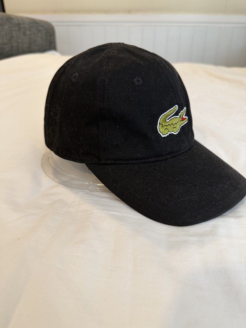 Lacoste Black Cap with Big Crocodile Logo (Category: Caps & Hats) located in Quezon City. Submitted by harringtonmnl (Listing ID 1451421740, Image 2). Description: - Classic black Lacoste cap - Features iconic green crocodile logo on front - 'LACOSTE' embroidered in yellow on the back - Adjustable strap for a comfortable fit - Perfect for everyday style .