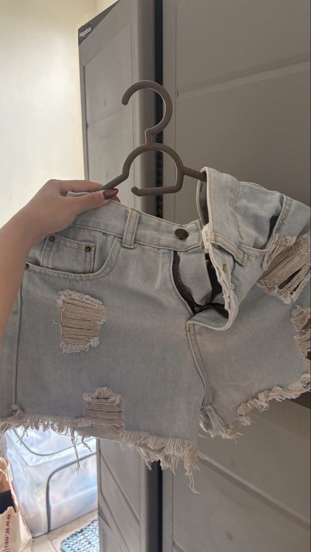 Light Wash Ripped Denim Shorts (Category: Shorts) located in Manila. Submitted by declutterbybeans (Listing ID 1451363009, Image 1). Description: - Light wash denim shorts - High-waisted style - Distressed rips and frayed hem - Zipper and button front closure - Two back pockets - Ideal for casual wear.