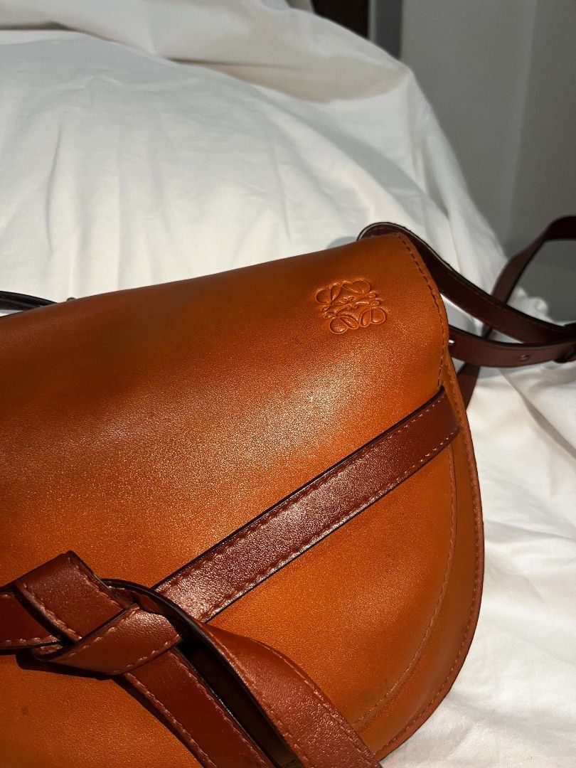 Loewe Gate Small Leather Crossbody Bag Tan (Category: Luxury Bags & Wallets) located in Antipolo. Submitted by happinessprelove (Listing ID 1451456776, Image 2). Description: - Loewe Gate bag - Color: Tan leather - Signature knot detail at the front - Adjustable strap for crossbody or shoulder wear - Gold-tone hardware - Suede lining interior - Made in Spain - Ideal everyday bag.