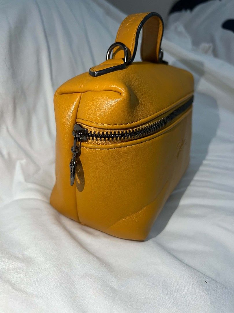 Longchamp Cosmetic Bag - Mustard Yellow (Category: Luxury Bags & Wallets) located in Antipolo. Submitted by happinessprelove (Listing ID 1451456612, Image 2). Description: - Cute Longchamp cosmetic bag - Vibrant mustard yellow color - Zipper closure with horse charm - Top handle - Detachable shoulder strap - Ideal for makeup or small essentials - Compact and easy to carry.