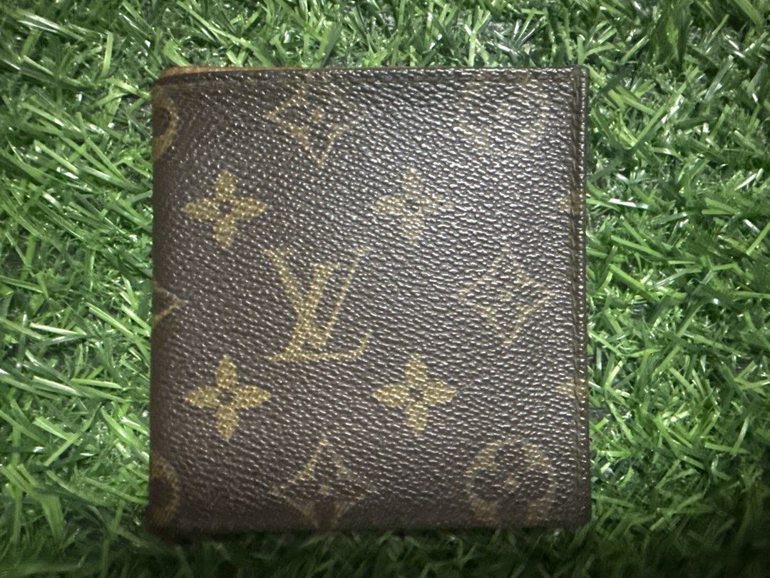 Louis Vuitton Monogram Bifold Wallet (Category: Luxury Bags & Wallets) located in Marilao. Submitted by its_me_bolinoy (Listing ID 1451330925, Image 1). Description: - Authentic Louis Vuitton monogram bifold wallet - Classic brown canvas with iconic LV pattern - Multiple card slots and compartments inside - Shows some signs of wear on edges and interior (consistent with regular use) - A timeless and essential accessory.