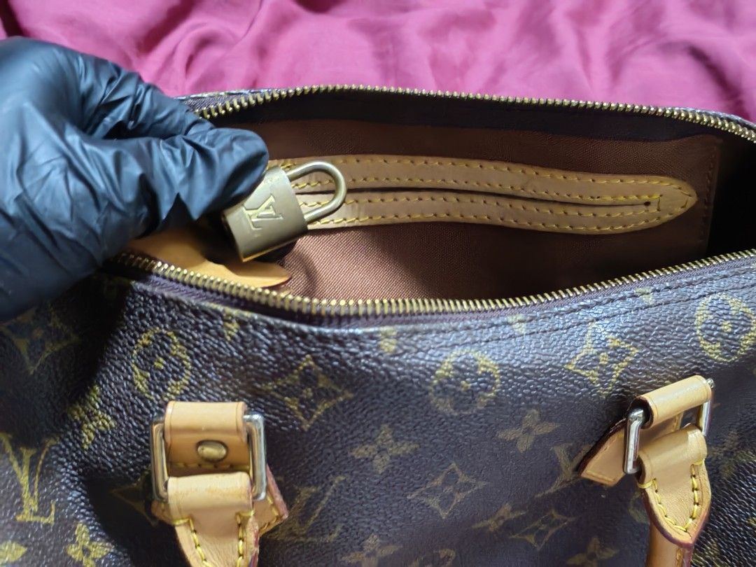 Louis Vuitton Monogram Speedy 30 (Category: Luxury Bags & Wallets) located in Quezon City. Submitted by dolcegioia (Listing ID 1451432074, Image 3). Description: -Classic, recognizable "doctor's bag" or barrel shape that defines the Speedy. ​Fabric and Hardware: ​It features the iconic Louis Vuitton Monogram pattern on coated canvas. ​-The trim and handles are made of natural cowhide (Vachetta) leather. -​The handles are attached to the body of t