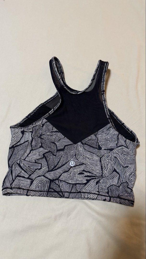 Lululemon Sports Bra Size 4 (Category: Activewear) located in Las Pinas. Submitted by mbisl (Listing ID 1451476292, Image 2). Description: - Lululemon sports bra - Stylish black and white geometric print - Mesh panel at the back for enhanced breathability - Comfortable and supportive straps - Features the Lululemon logo on the back - Perfect for workouts or layering.