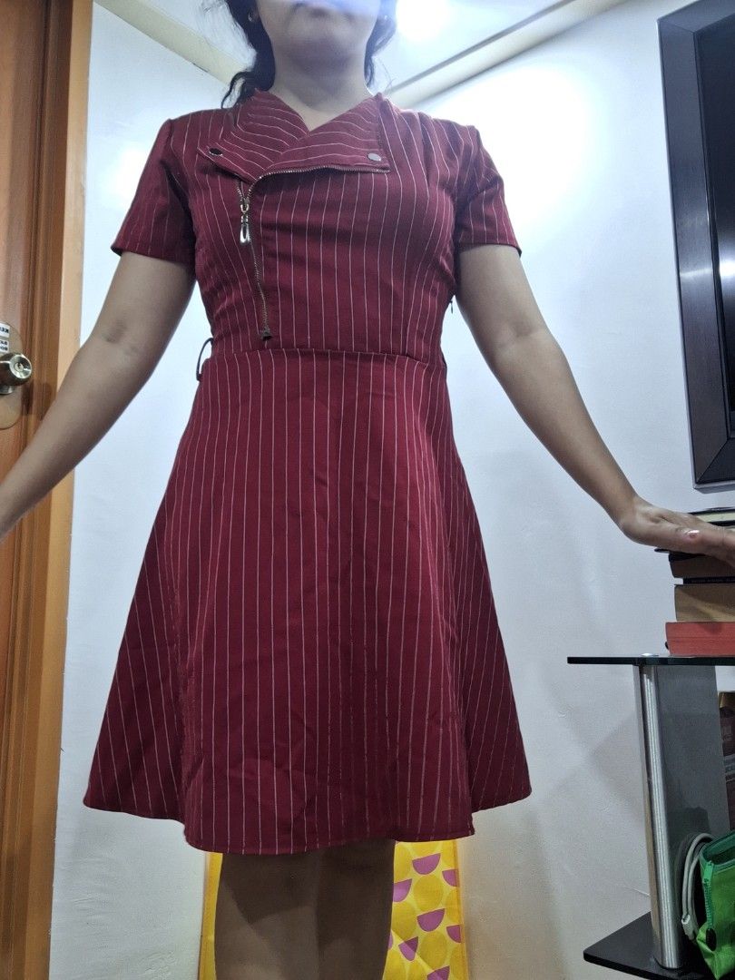 Maroon Striped Zipper Dress (Category: Dresses) located in Antipolo. Submitted by blueverly (Listing ID 1451485924, Image 2). Description: - Fits medium size - Stylish maroon dress with subtle white pinstripes. - Unique asymmetrical zipper detail on the front. - Flattering belted waist. - Knee-length skirt. - Ideal for both casual outings and work attire..