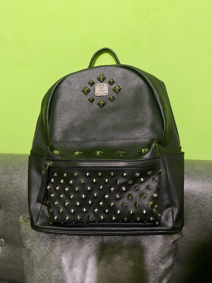 MCM STUDDED BACKPACK (Category: Backpacks) located in Dagupan City. Submitted by casadebayongph (Listing ID 1451327406, Image 2). Description: - Authentic MCM backpack - Color: Black leather - Embellished with silver studs all over - Front zip pocket - Side pockets - Adjustable straps with MCM branding - Interior MCM logo tag - Ideal for everyday use Issue last pic missing one rebate but pretty bag overall..