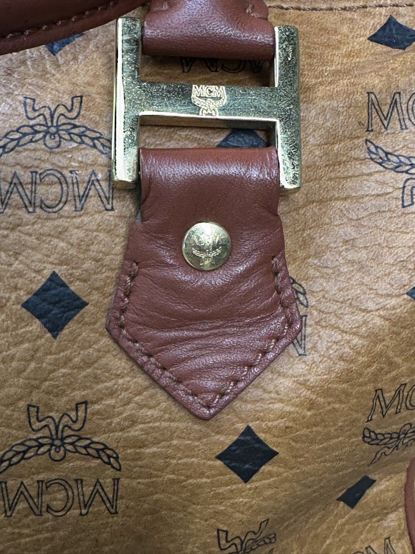 MCM Visetos Monogram Boston Bag / Handbag (Cognac) (Category: Luxury Bags & Wallets) located in Urdaneta. Submitted by redeemedcollective (Listing ID 1451487802, Image 3). Description: Vintage MCM Boston bag in cognac monogram canvas with leather trim and brass hardware. Features a top-zip closure, dual handles, and a spacious interior pocket. Offered in great vintage condition with a natural leather patina. DM for measurements and shipping detai