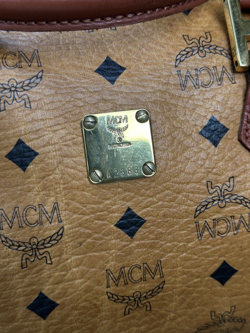 MCM Visetos Monogram Boston Bag / Handbag (Cognac) (Category: Luxury Bags & Wallets) located in Urdaneta. Submitted by redeemedcollective (Listing ID 1451487802, Image 2). Description: Vintage MCM Boston bag in cognac monogram canvas with leather trim and brass hardware. Features a top-zip closure, dual handles, and a spacious interior pocket. Offered in great vintage condition with a natural leather patina. DM for measurements and shipping detai