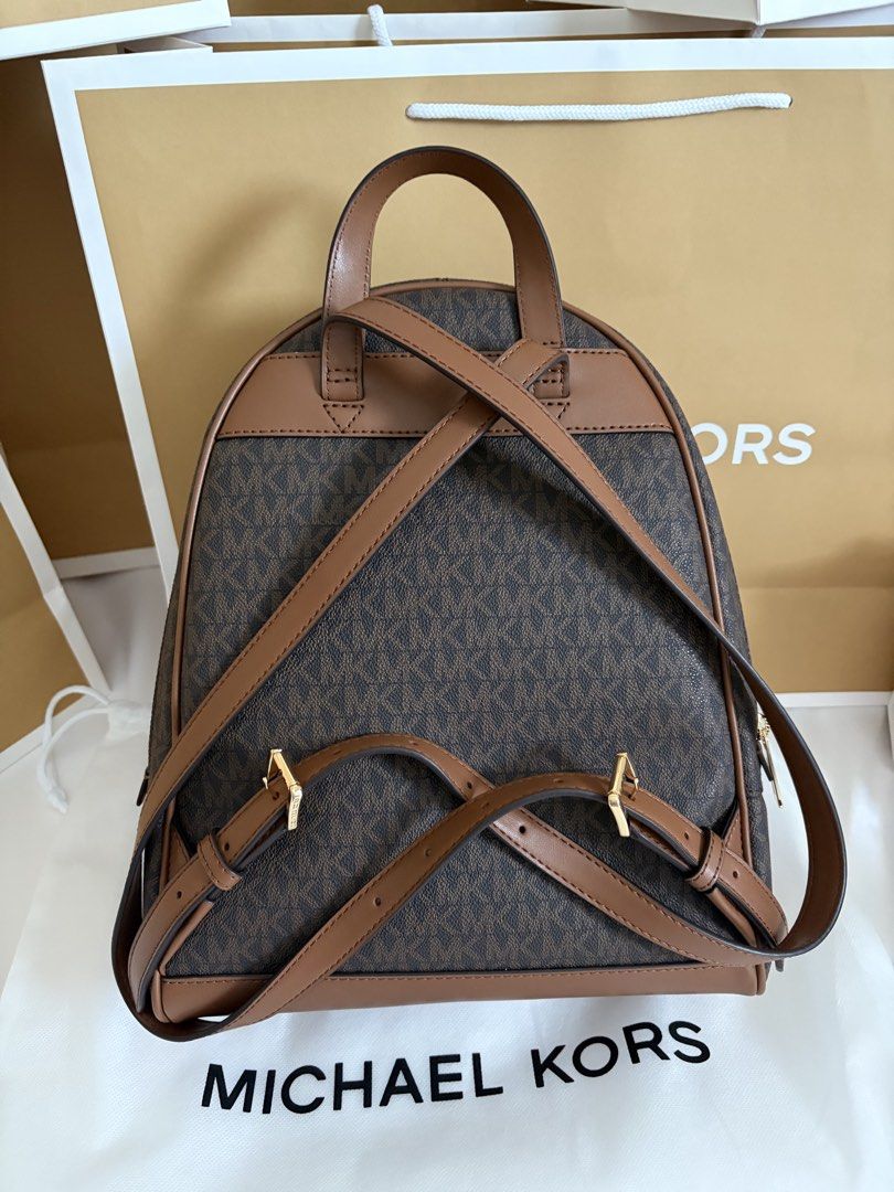 Michael Kors Signature Logo Backpack Brown (Category: Backpacks) located in Manila. Submitted by chiiisells_ (Listing ID 1451394902, Image 2). Description: Original Price is PhP 31,000.00 (82,500.00 yen) - Authentic Michael Kors backpack - Signature brown MK print - Gold hardware and brown leather trim - Main compartment with zip closure - Adjustable shoulder straps - Ideal for everyday use or travel - Comes with original dust bag.