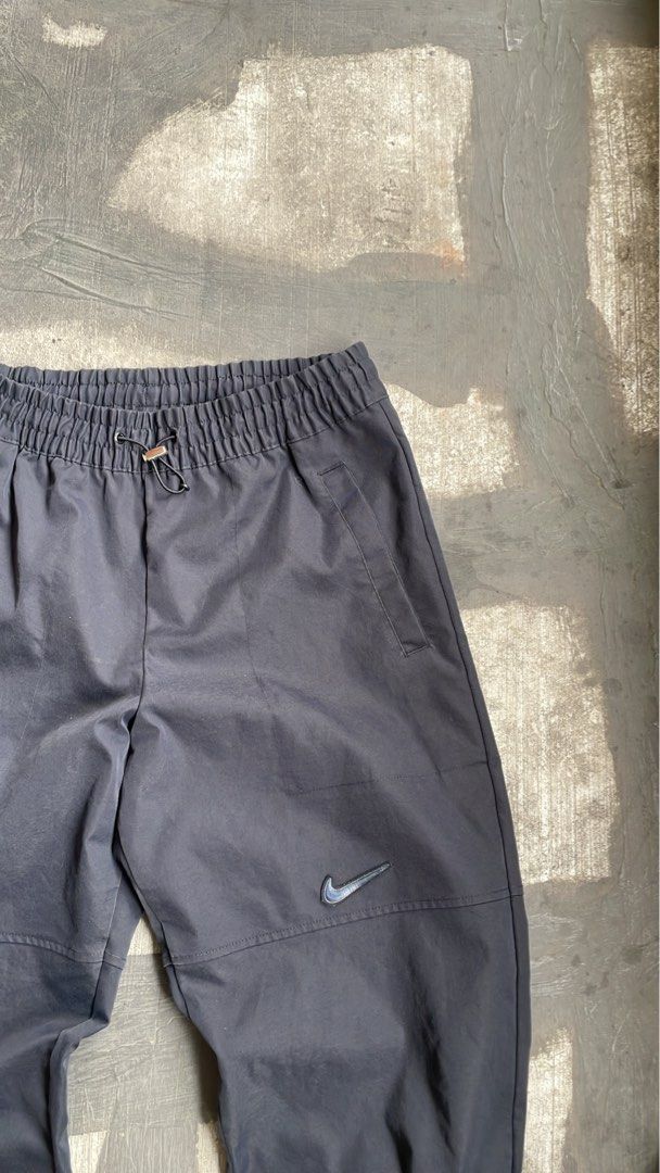 Nike Sportswear Woven Pants (Category: Activewear) located in Marikina City. Submitted by 4af966271c192b2f74291393ce6f74 (Listing ID 1451415815, Image 3). Description: These black Nike Sportswear Swoosh woven pants feature an elastic waistband and ribbed cuffs. Size Large Waist 32-34.