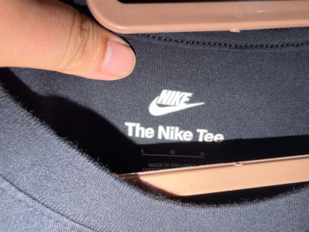 Nike Tee T-Shirt Black Size L (Category: Tshirts & Polo Shirts ) located in Tagudin. Submitted by 77sleep (Listing ID 1451381619, Image 2). Description: - Black Nike T-shirt - Size: Large (L) - Material: 100% Cotton - Design: Classic Nike logo with yellow and red swoosh - Tag: 'The Nike Tee' - Perfect for casual everyday wear.