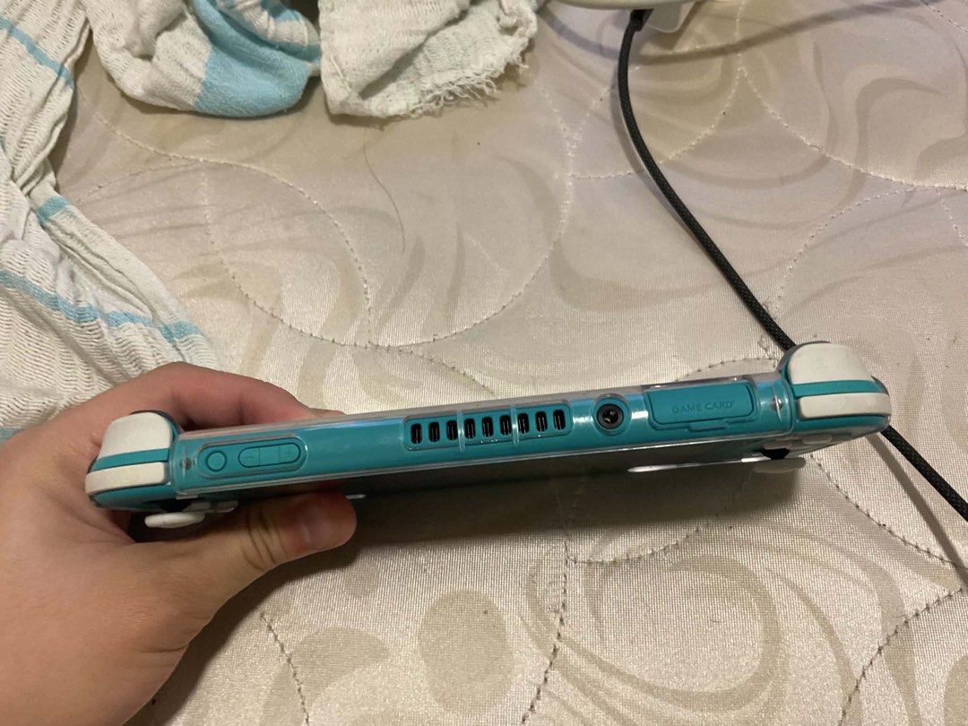 Nintendo Switch Lite Turquoise Animal Crossing Edition (Category: Nintendo) located in Manila. Submitted by cosmicshark.a27f1b (Listing ID 1451337008, Image 3). Description: Turquoise Nintendo Switch Lite Animal Crossing Edition with leaf design Comes with a clear protective case Original Price: P9,950 Reason for Selling: Need urgent funds for personal emergency Condition: Only used it for a month, still like new, slight crack in tempered glass o