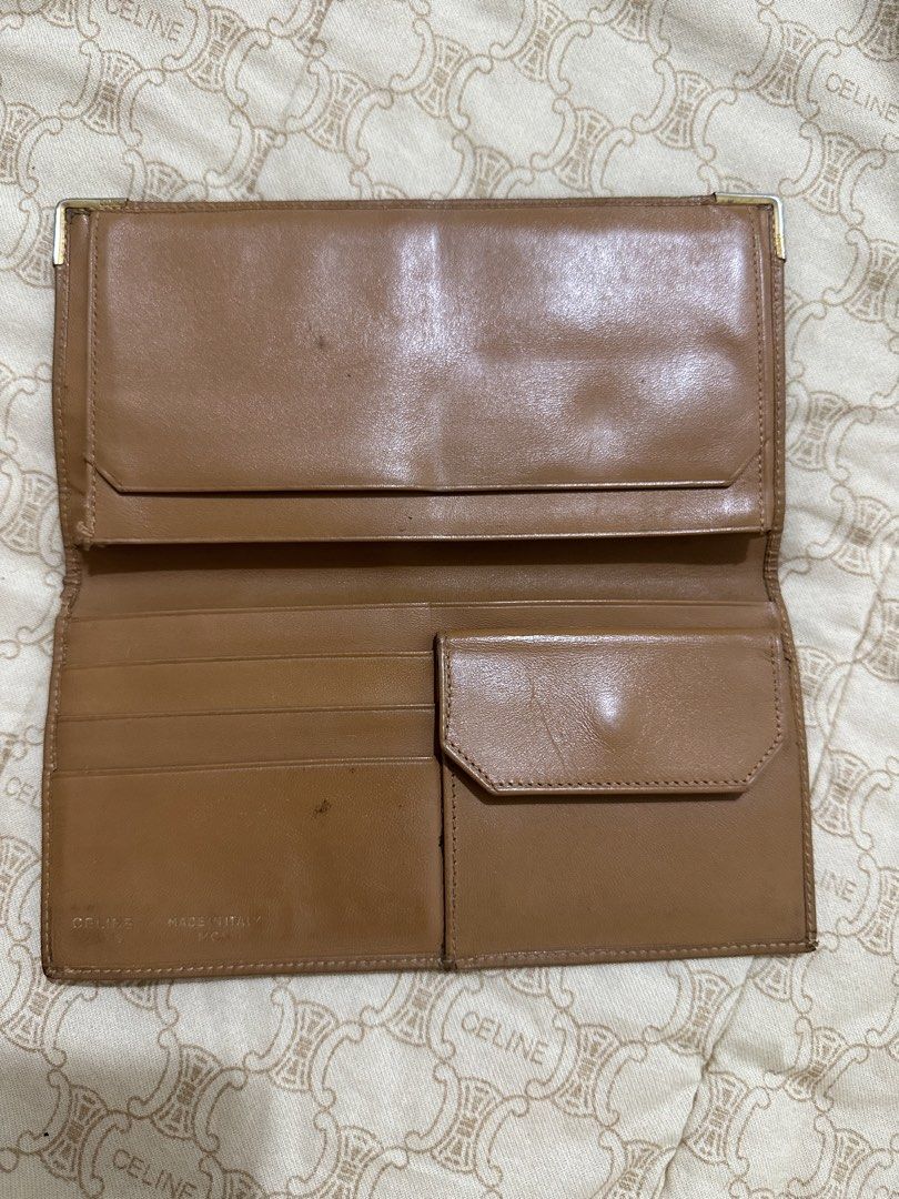 ORIGINAL Celine Paris Monogram Bi-fold Wallet (Category: Luxury Bags & Wallets) located in Naga. Submitted by bag.net (Listing ID 1451468549, Image 3). Description: - Classic Celine wallet with iconic monogram print (Guaranteed original 💯 moneyback if fake ) - Tan leather interior with multiple card slots - Includes a coin pouch - Made in Italy - Interior shows some signs of wear - A timeless and stylish accessory.