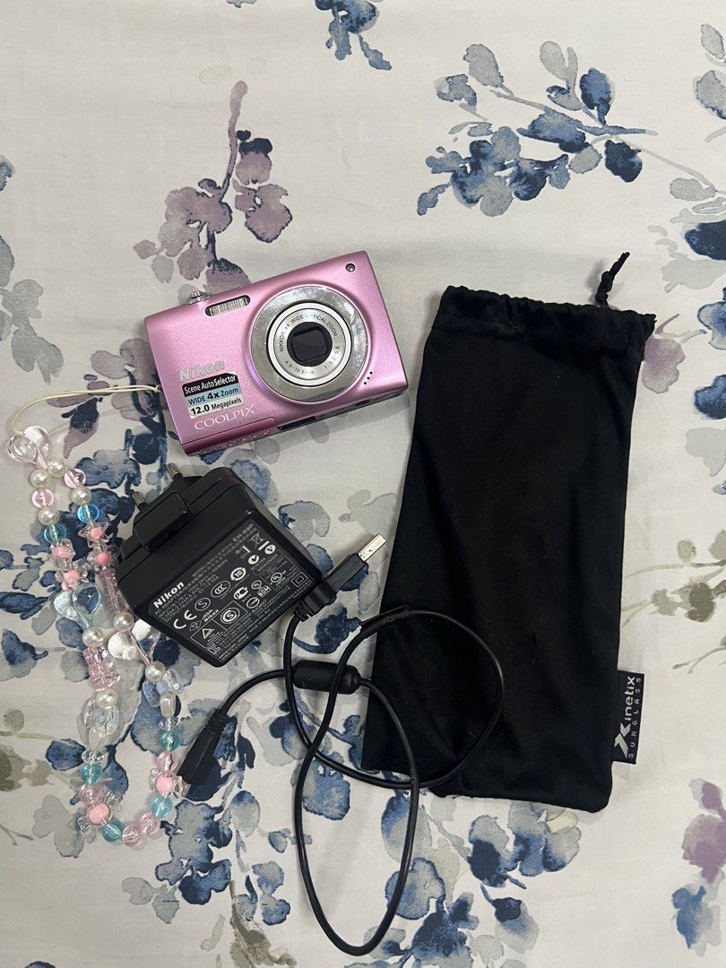 Pink Nikon Coolpix s2500 12.0 Megapixels Digital Camera with Strap (Category: Cameras) located in Manila. Submitted by lindseybentables (Listing ID 1451430400, Image 2). Description: Pink Nikon Coolpix Digital Camera - 12.0 Megapixels - No issue taking photos or focusing on subject - Cosmetics: No scratches on body except some scratches on the silver ring due to normal use (camera area) Inclusions: - Beaded strap - Original charger - Original bat