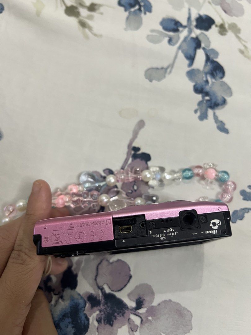 Pink Nikon Coolpix s2500 12.0 Megapixels Digital Camera with Strap (Category: Cameras) located in Manila. Submitted by lindseybentables (Listing ID 1451430400, Image 3). Description: Pink Nikon Coolpix Digital Camera - 12.0 Megapixels - No issue taking photos or focusing on subject - Cosmetics: No scratches on body except some scratches on the silver ring due to normal use (camera area) Inclusions: - Beaded strap - Original charger - Original bat