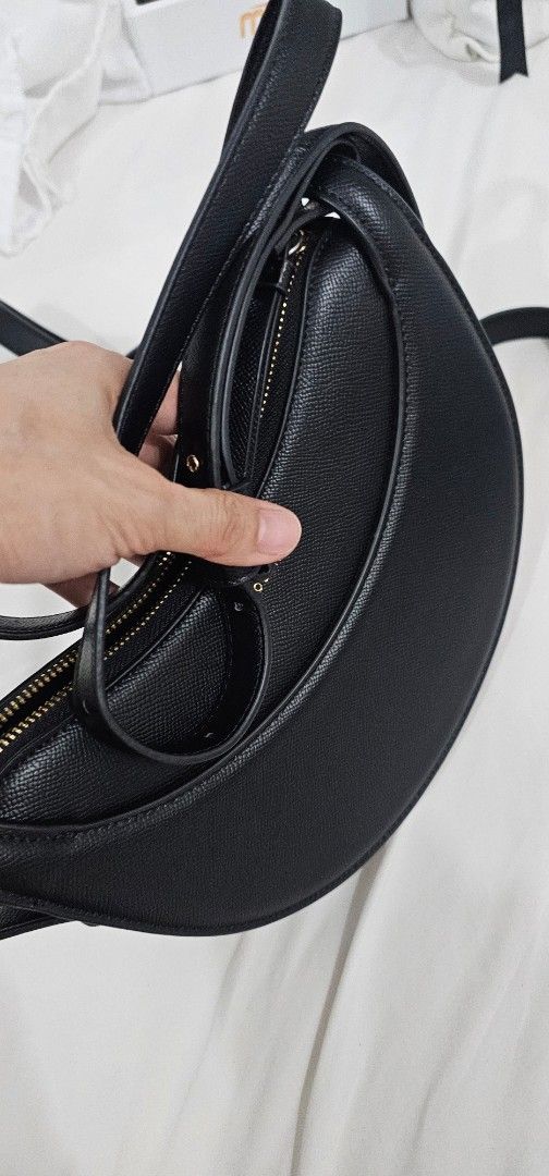 Polene (Category: Shoulder Bags) located in Quezon City. Submitted by angelleprelovedco (Listing ID 1451379998, Image 3). Description: Chic black crescent shoulder bag made of textured leather. Features a secure zipper closure, interior card slots, and an adjustable strap. Perfect for daily wear..
