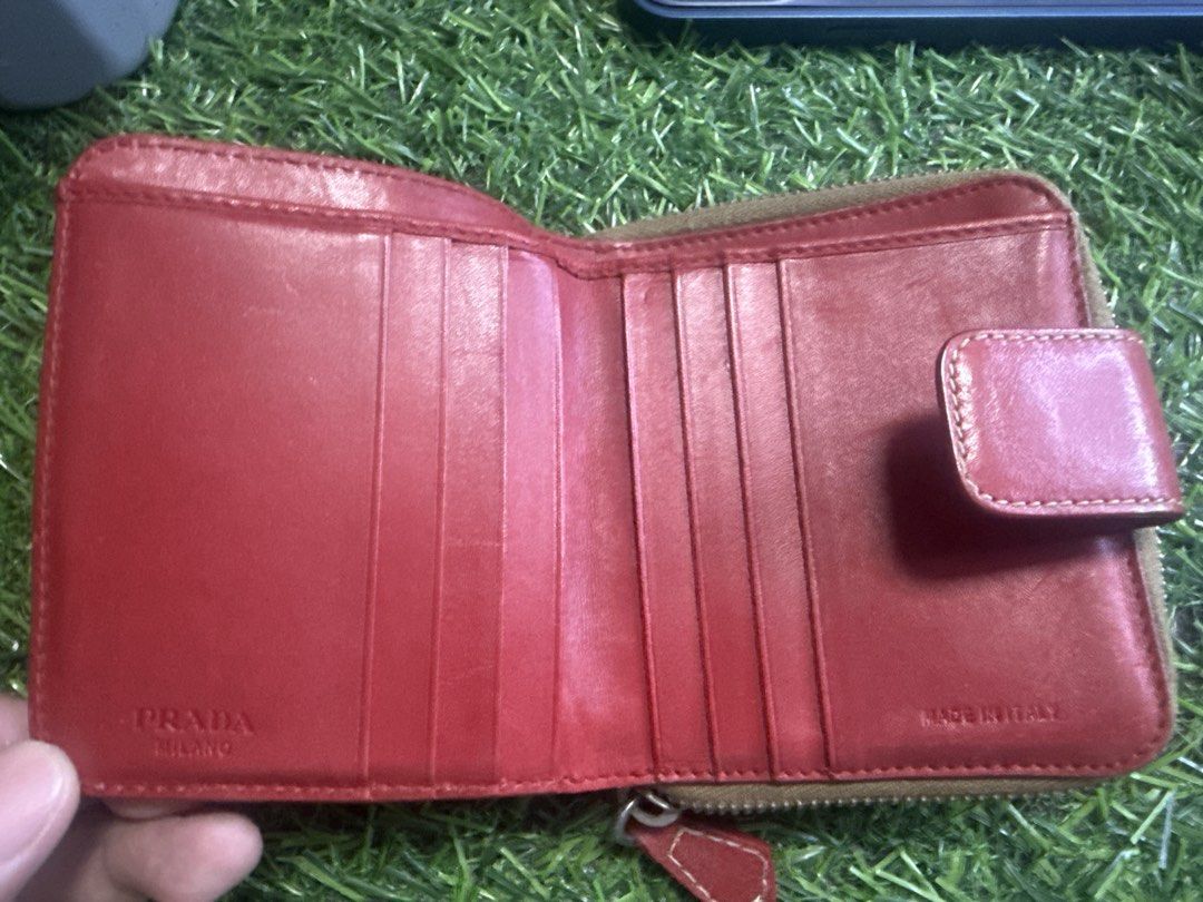 Prada Milano Bi-fold Wallet (Category: Luxury Bags & Wallets) located in Marilao. Submitted by its_me_bolinoy (Listing ID 1451390126, Image 3). Description: - Authentic Prada bi-fold wallet - Luxurious red leather interior - Multiple card slots for organization - Iconic Prada Milano logo pattern exterior - Secure snap button closure - Expertly crafted in Italy - with Authenticity Card.