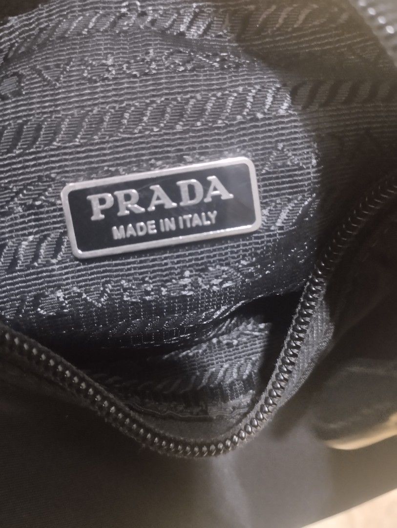 Prada mini bag (Category: Luxury Bags & Wallets) located in Bacoor. Submitted by nigel_008 (Listing ID 1451330650, Image 3). Description: Prada Re-edition 2000 mini bag features the brand's iconic enameled metal triangle logo and a woven tape handle..