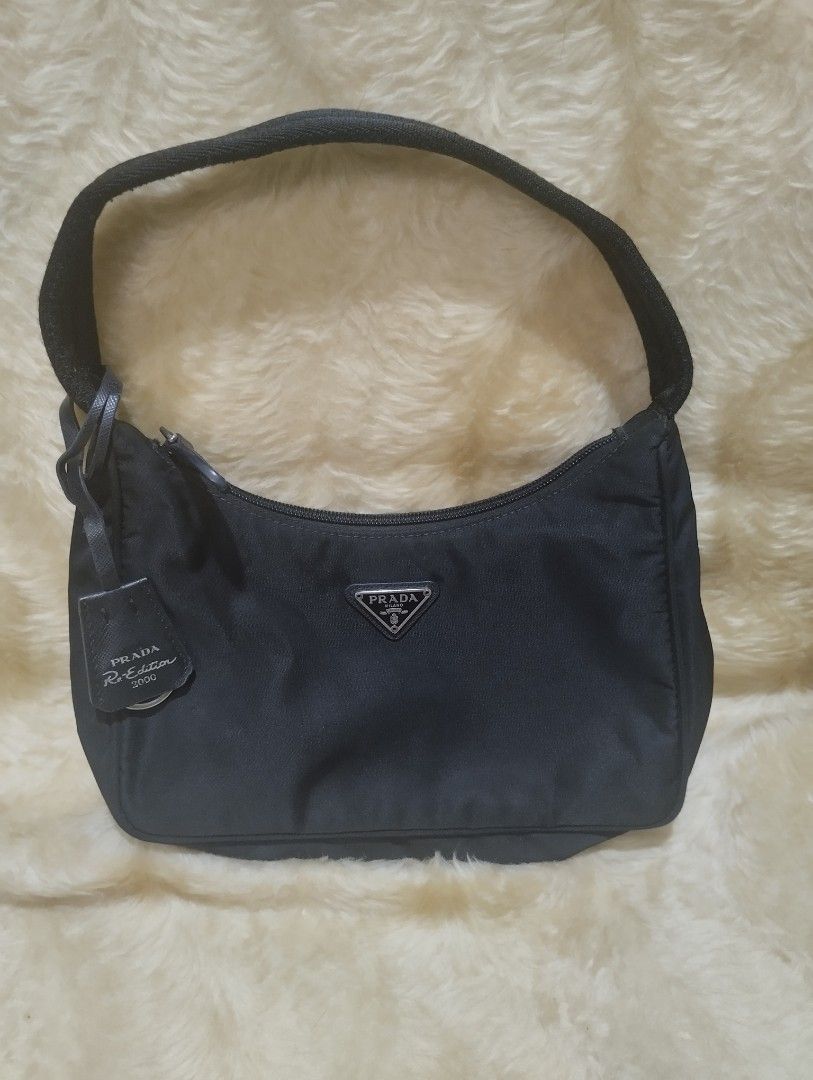 Prada mini bag (Category: Luxury Bags & Wallets) located in Bacoor. Submitted by nigel_008 (Listing ID 1451330650, Image 1). Description: Prada Re-edition 2000 mini bag features the brand's iconic enameled metal triangle logo and a woven tape handle..