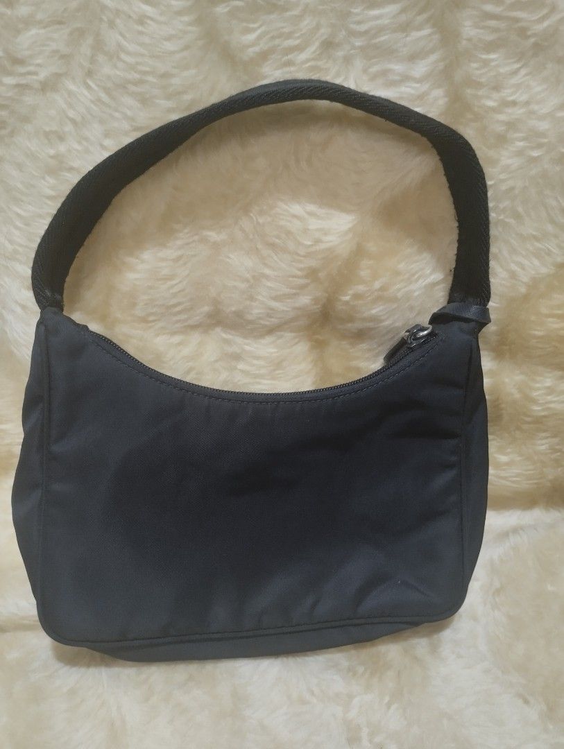 Prada mini bag (Category: Luxury Bags & Wallets) located in Bacoor. Submitted by nigel_008 (Listing ID 1451330650, Image 2). Description: Prada Re-edition 2000 mini bag features the brand's iconic enameled metal triangle logo and a woven tape handle..