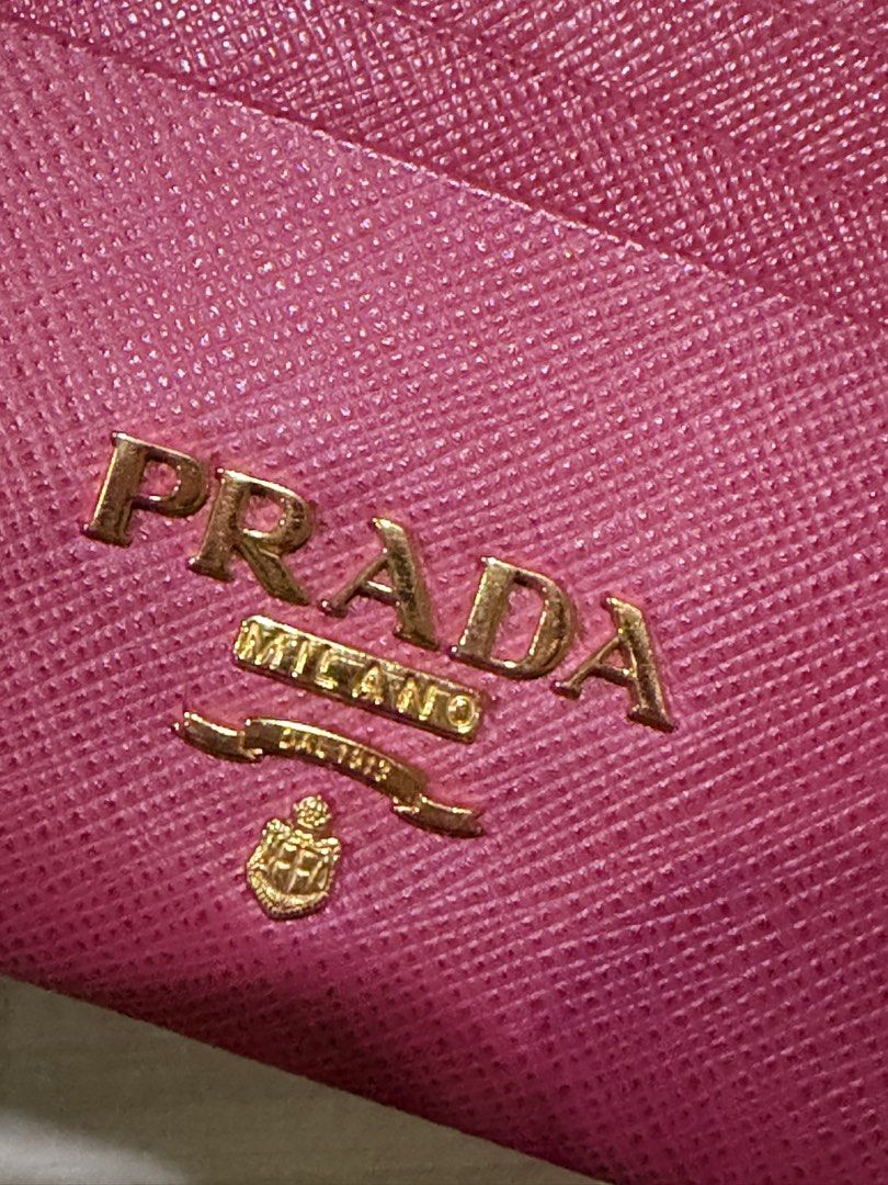 PRADA Saffiano Leather Card Holder Pink (Category: Luxury Bags & Wallets) located in Pasig City. Submitted by theclosetcasemanila (Listing ID 1451479569, Image 3). Description: - Authentic Prada card holder in pink Saffiano leather - Includes original box and authenticity card - Multiple card slots for organization - Zippered compartment for secure storage - Elegant gold hardware details - Perfect for keeping your essentials tidy Excellent condit