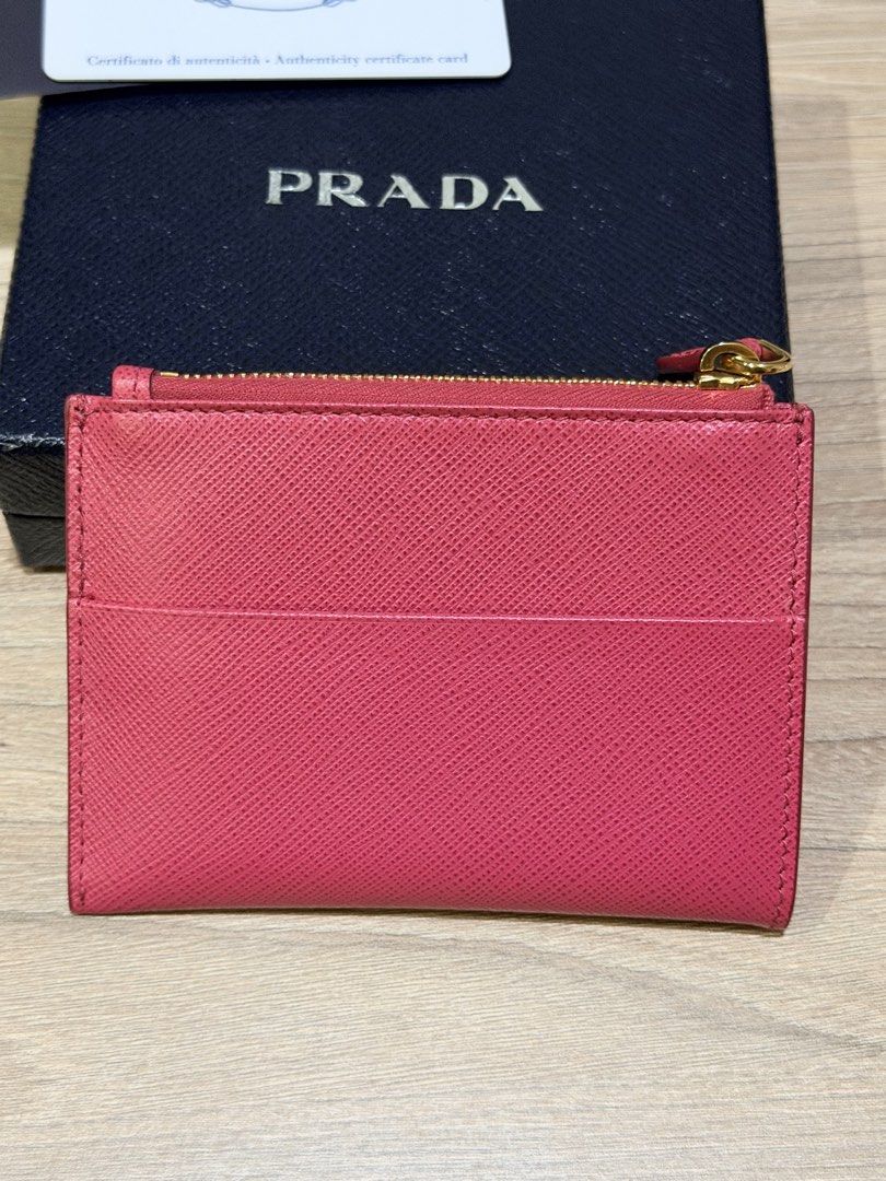 PRADA Saffiano Leather Card Holder Pink (Category: Luxury Bags & Wallets) located in Pasig City. Submitted by theclosetcasemanila (Listing ID 1451479569, Image 2). Description: - Authentic Prada card holder in pink Saffiano leather - Includes original box and authenticity card - Multiple card slots for organization - Zippered compartment for secure storage - Elegant gold hardware details - Perfect for keeping your essentials tidy Excellent condit
