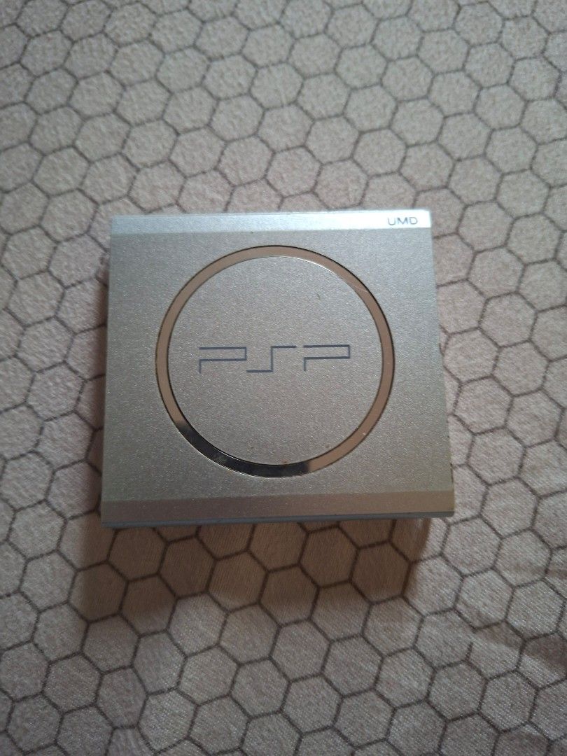 PSP Cover /Handheld Console (Category: PlayStation) located in Rizal. Submitted by carou66859 (Listing ID 1451345422, Image 1). Description: This is a Sony PSP-3000 handheld console. The selected region highlights the UMD (Universal Media Disc) drive door on the back. This specific unit appears to be the Mystic Silver color variant. -Price is 295 only Rizal area.Shipping sagot ng buyer..