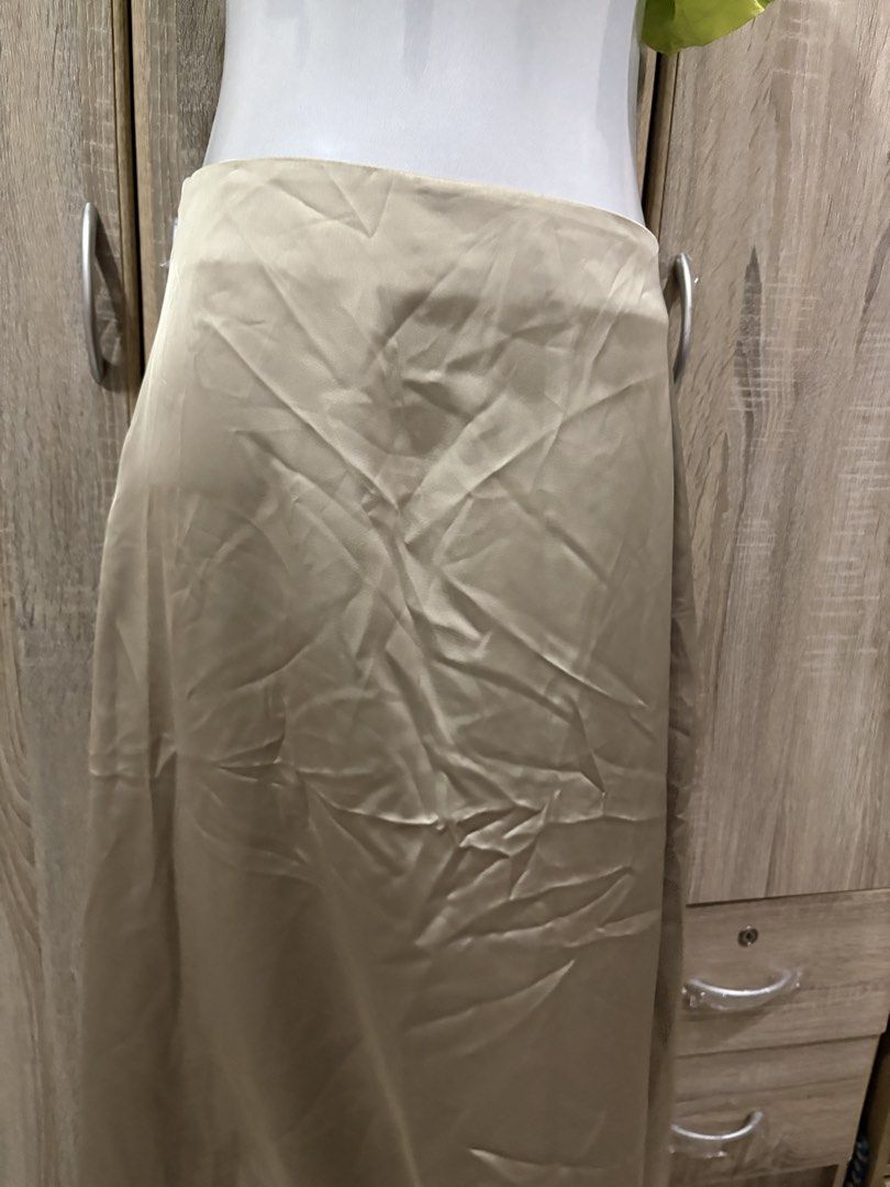 Satin Midi Skirt - Saige Green (Category: Skirts) located in Manila. Submitted by roseannn_ (Listing ID 1451457792, Image 2). Description: - Flowy satin midi skirt - Neutral beige color - Side zipper closure - Versatile for dressing up or down - Perfect for any occasion - Easy to style with various tops.