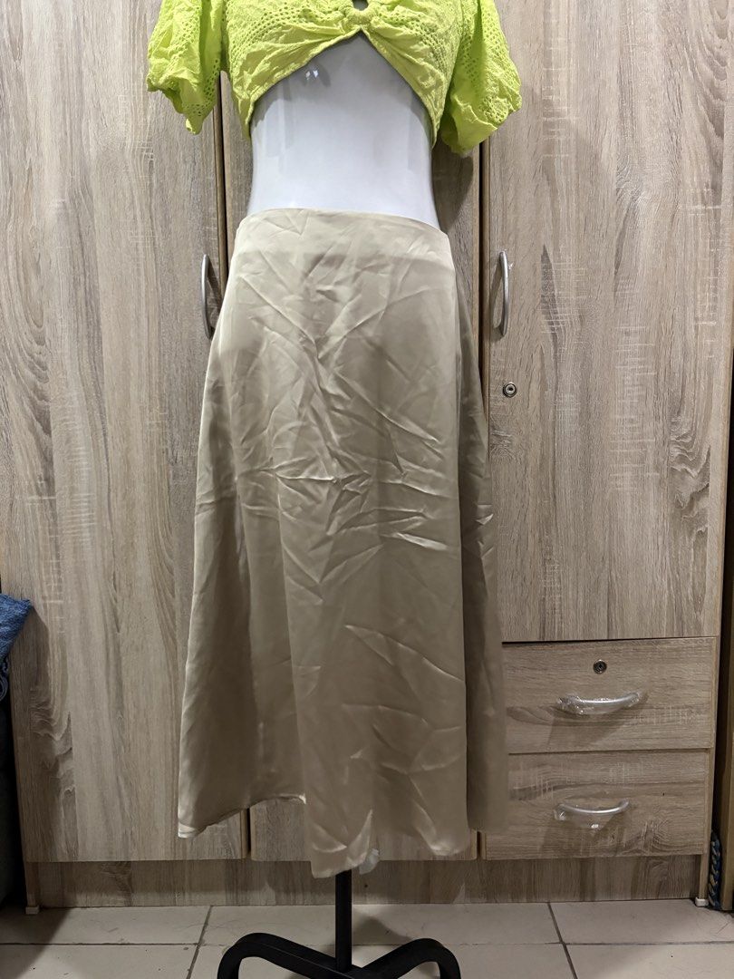 Satin Midi Skirt - Saige Green (Category: Skirts) located in Manila. Submitted by roseannn_ (Listing ID 1451457792, Image 1). Description: - Flowy satin midi skirt - Neutral beige color - Side zipper closure - Versatile for dressing up or down - Perfect for any occasion - Easy to style with various tops.
