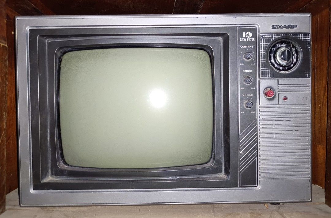 Sharp 14-inch CRT Television (Category: TV) located in Claveria. Submitted by raiserx (Listing ID 1451336477, Image 1). Description: - Vintage 14-inch Sharp CRT Television - Features manual controls for contrast, brightness, and V-hold - Distinctive red power button - Original tuning dial still intact - Defective or not working, for display only.