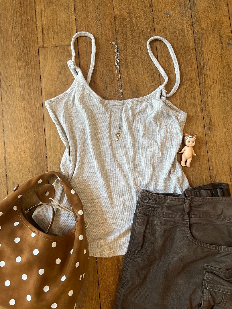 simple grey tank top (Category: Other Tops) located in Kuala Lumpur. Submitted by aliciaayuu84078 (Listing ID 1451370226, Image 1). Description: - Grey ribbed spaghetti strap tank top - Brown suede-like hobo bag with white polka dots - Dark grey cargo pants with multiple pockets - Delicate silver necklace with a small pendant - Ideal for a casual day out.