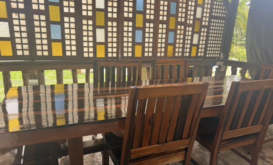 Solid Wood Dining Table and Chairs Set (Category: Tables & Sets) located in Pasig City. Submitted by silverrabbit_997049 (Listing ID 1451377650, Image 3). Description: - Beautiful solid wood dining set 12 seater - Includes large table and 6 chairs - Rich, dark wood finish with natural grain patterns - Comfortable and sturdy chairs - Perfect for family gatherings and entertaining guests - Ideal for dining room or patio.