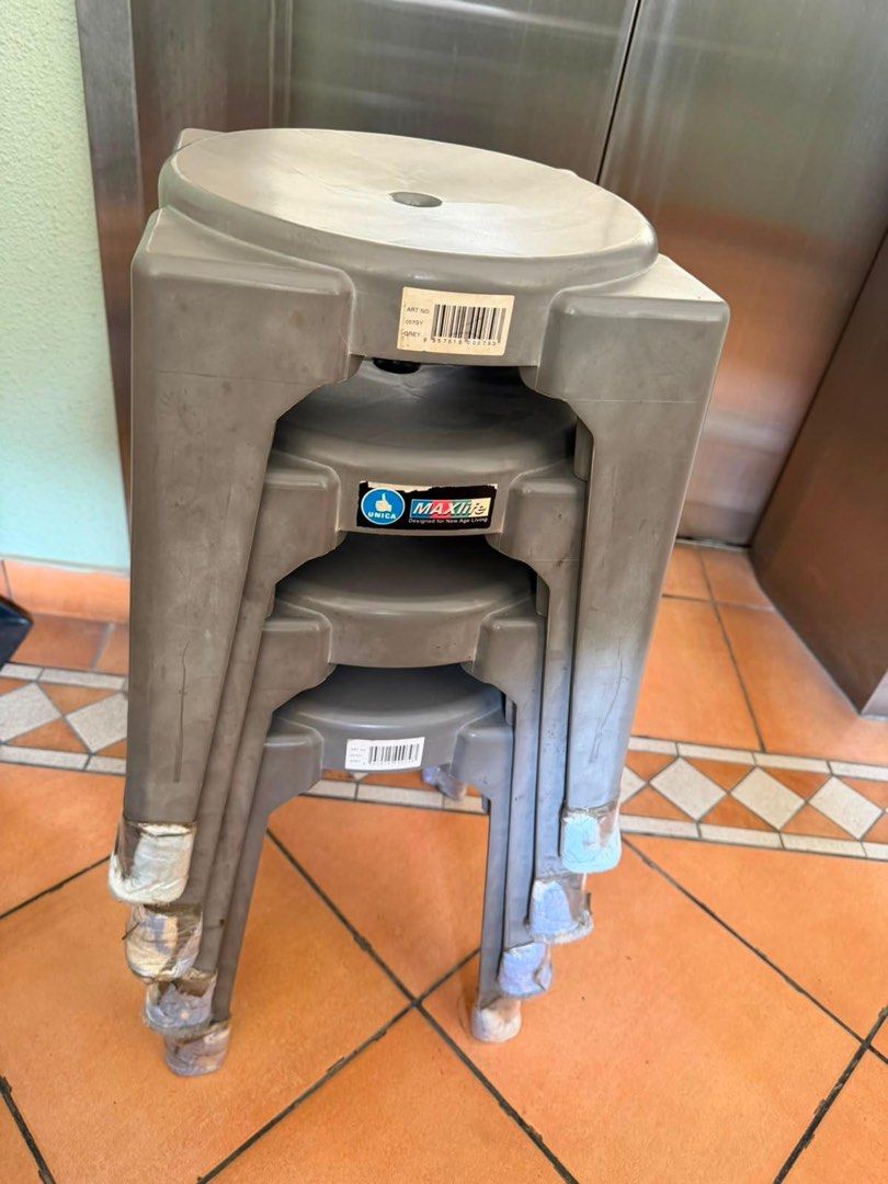 Stackable Plastic Stools (Category: Chairs) located in Singapore. Submitted by notsam (Listing ID 1451397748, Image 1). Description: - Set of 4 grey plastic stools - Brand: MAXIMA - Stackable design for space-saving - Sturdy and functional - Ideal for extra seating Each is $4 .