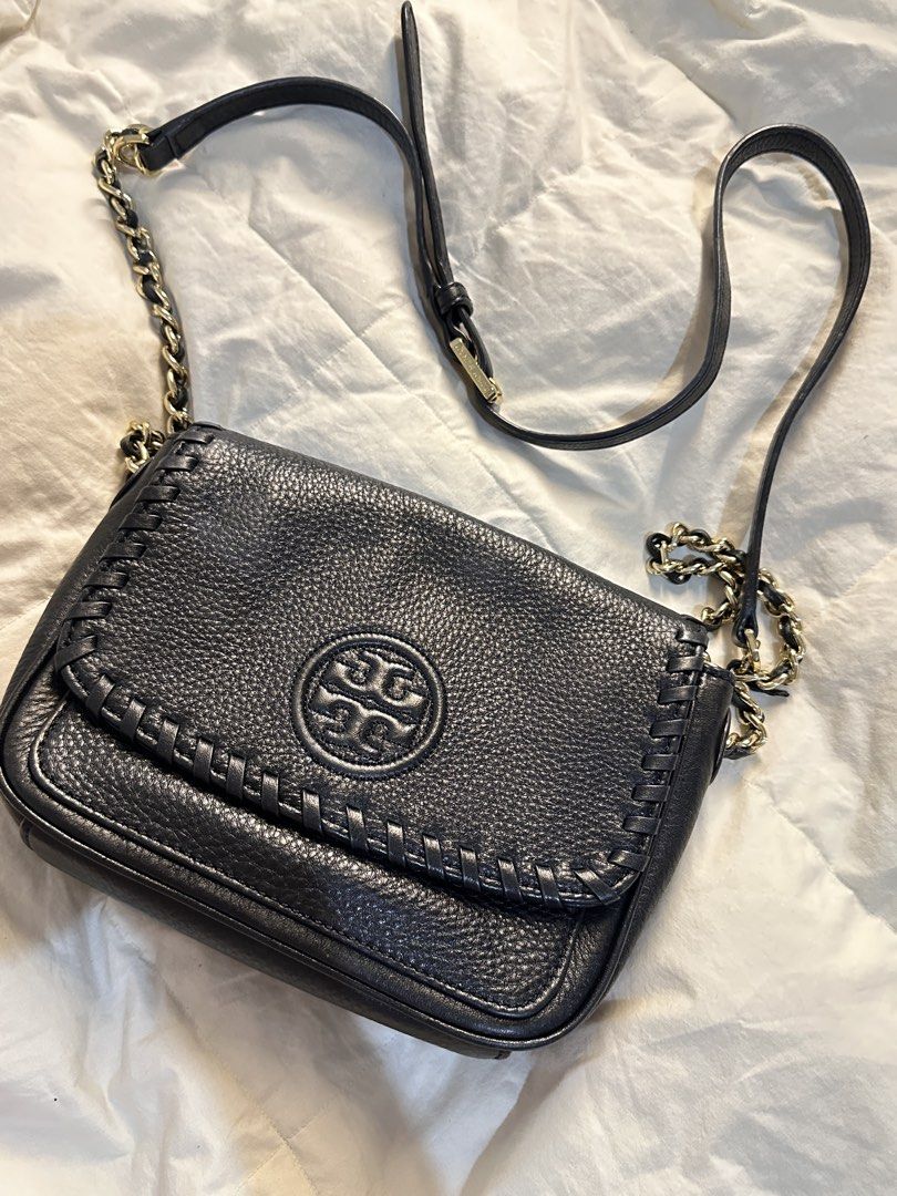 Tory Burch Black Leather Shoulder Bag with Chain Strap (Category: Luxury Bags & Wallets) located in Manila. Submitted by oddturtle.cd6ea5 (Listing ID 1451420310, Image 1). Description: - Genuine black leather Tory Burch bag - Iconic Tory Burch logo on front flap - Elegant woven detail along flap edge - Interior zippered pocket and card slots for organization - Stylish gold-tone chain strap - Versatile for everyday wear or evening events.
