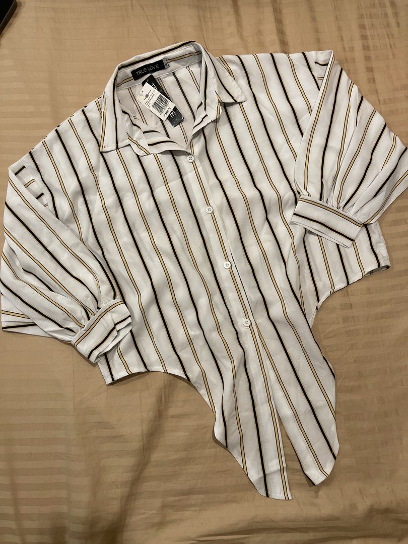 TRUE LOVE Striped Button-Up Shirt Size M (Category: Shirts) located in Marikina City. Submitted by bimbems (Listing ID 1451448493, Image 1). Description: - Classic white shirt with stylish black and yellow stripes. - Button-up front with a neat collar. - Long sleeves with adjustable buttoned cuffs. - Unique tie-front hem detail. - Brand new, with original tag still attached. RFS: decluttering Loc 📍: Marikina City Jnt Delivery - Purchased from Th