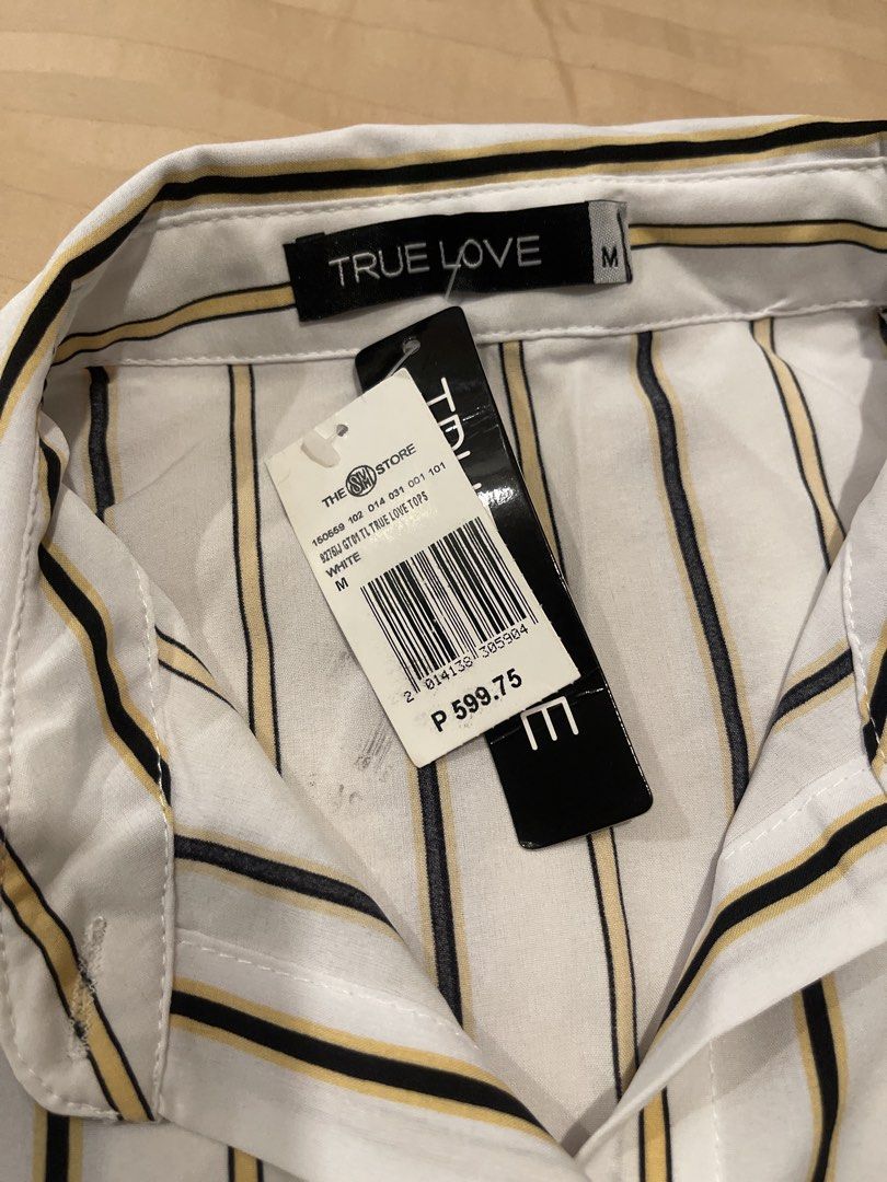 TRUE LOVE Striped Button-Up Shirt Size M (Category: Shirts) located in Marikina City. Submitted by bimbems (Listing ID 1451448493, Image 2). Description: - Classic white shirt with stylish black and yellow stripes. - Button-up front with a neat collar. - Long sleeves with adjustable buttoned cuffs. - Unique tie-front hem detail. - Brand new, with original tag still attached. RFS: decluttering Loc 📍: Marikina City Jnt Delivery - Purchased from Th