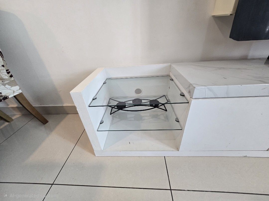 TV Console / Cabinet for Sa (Category: TV Consoles) located in Kuala Lumpur. Submitted by sosokarmi54314 (Listing ID 1451406365, Image 3). Description: Description: Modern white TV cabinet with marble-style top. Features lower storage cabinets and side glass shelves for decor or media players. ​Condition: Used. Has some visible peeling/scratches on the top and edge (shown in pictures) — perfect for a quick DIY fix or wrapping. ​Price: RM 130 (Neg