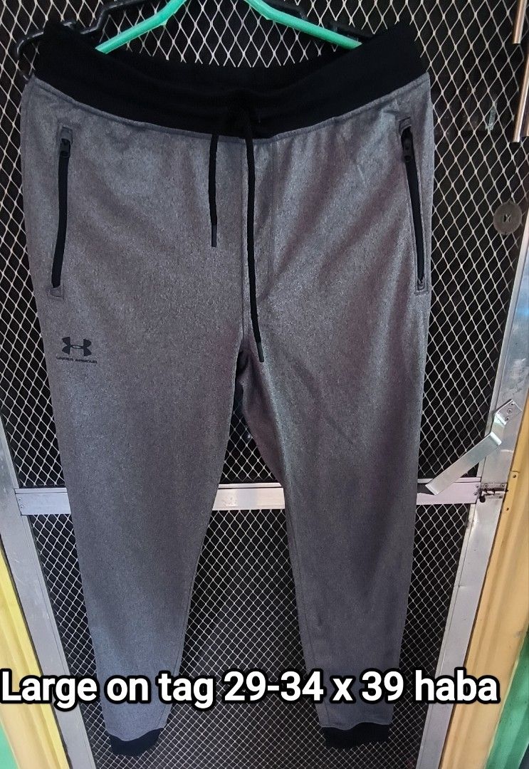 Under Armour Grey Joggers Sweatpants Size L (Category: Joggers) located in Manila. Submitted by itsmelawrence (Listing ID 1451477569, Image 1). Description: - Grey Under Armour Joggers - Size: Large (L) on tag - Waist fit: 29-34 inches - Length: 39 inches - Zippered pockets on both sides - Adjustable drawstring waist - Ideal for workouts and casual wear.