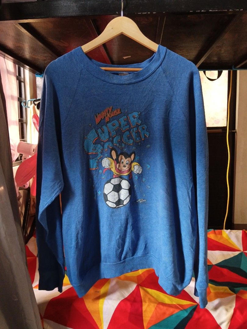 Vintage Mighty Mouse Super Soccer Sweatshirt (Category: Coats, Jackets and Outerwear) located in Lucban. Submitted by thriftriel (Listing ID 1451416097, Image 3). Description: - Vintage Mighty Mouse sweatshirt -23.5x28 in - Features Mighty Mouse playing soccer - Bright and fun graphic - Made by Fruit of the Loom - Classic retro clothing piece - Shows some signs of wear, but plenty of life left.