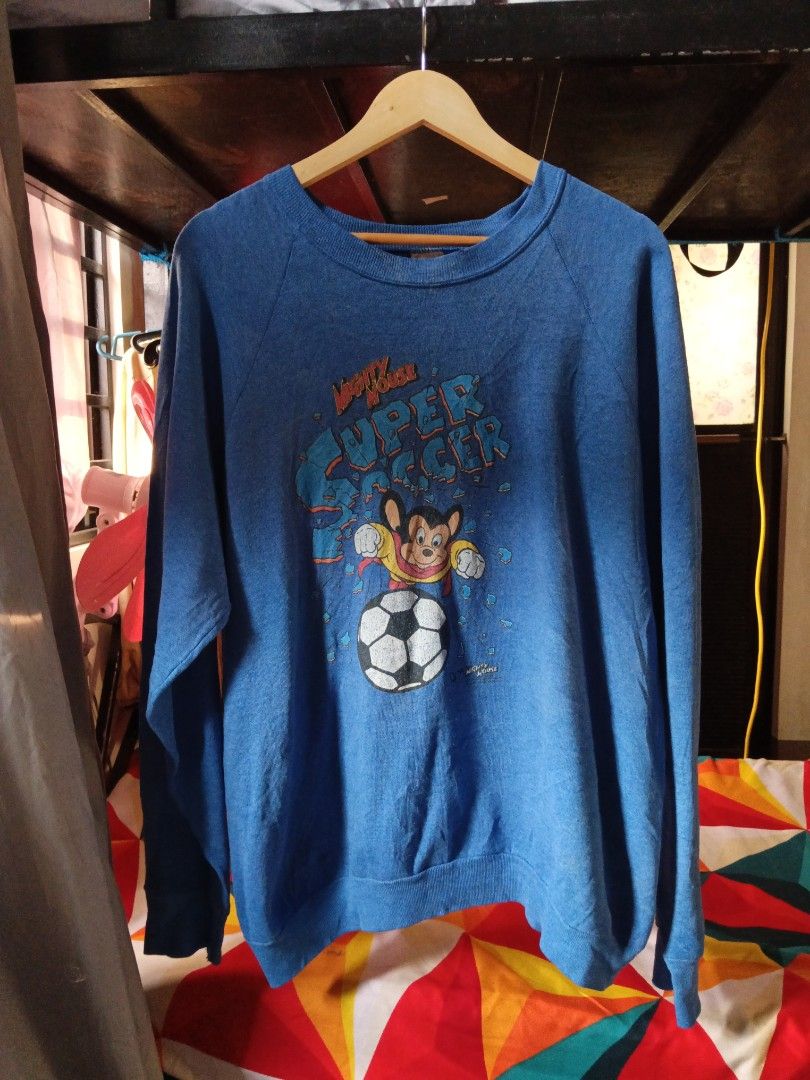 Vintage Mighty Mouse Super Soccer Sweatshirt (Category: Coats, Jackets and Outerwear) located in Lucban. Submitted by thriftriel (Listing ID 1451416097, Image 1). Description: - Vintage Mighty Mouse sweatshirt -23.5x28 in - Features Mighty Mouse playing soccer - Bright and fun graphic - Made by Fruit of the Loom - Classic retro clothing piece - Shows some signs of wear, but plenty of life left.