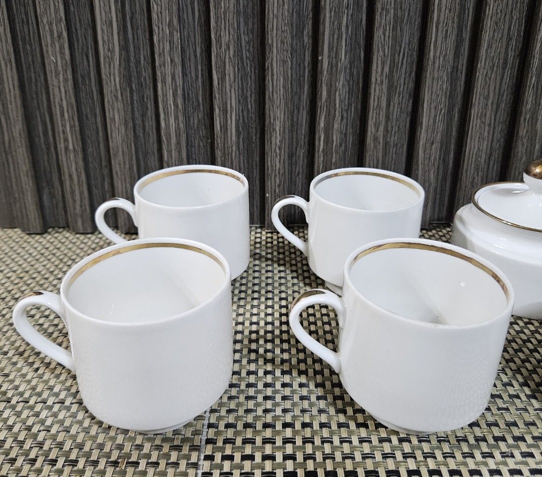 White Ceramic Tea Set with Gold Trim (Category: Coffee & Tea Tableware) located in Rizal. Submitted by cherry_garcia (Listing ID 1451386420, Image 3). Description: - Complete white ceramic tea set - Includes: 4 cups, sugar bowl with lid, creamer pitcher, double condiment dish with lids - Features elegant gold trim on cup and pitcher rims - Sugar bowl has a decorative gold knob - Condiment dish includes a convenient handle - Ideal for serving gues