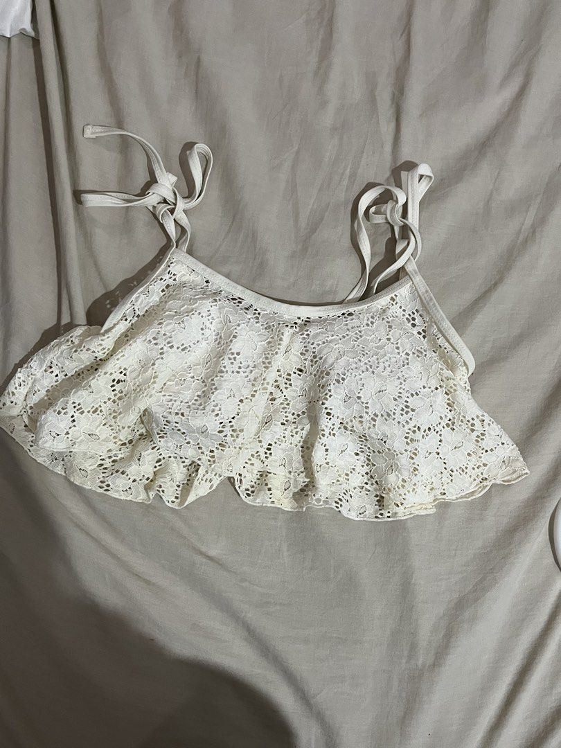 White Lace Bikini Top with Tie Straps (Category: Bikinis & Swimsuits) located in Manila. Submitted by mxinii (Listing ID 1451430848, Image 2). Description: - Cute white lace bikini top - Features a ruffled hemline - Ties at the shoulders and back for adjustable fit - Built-in bra cups for support - Ideal for beach or pool days - Chic and summery style.