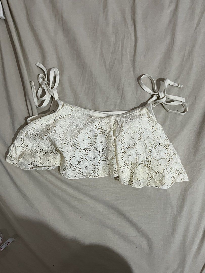 White Lace Bikini Top with Tie Straps (Category: Bikinis & Swimsuits) located in Manila. Submitted by mxinii (Listing ID 1451430848, Image 1). Description: - Cute white lace bikini top - Features a ruffled hemline - Ties at the shoulders and back for adjustable fit - Built-in bra cups for support - Ideal for beach or pool days - Chic and summery style.