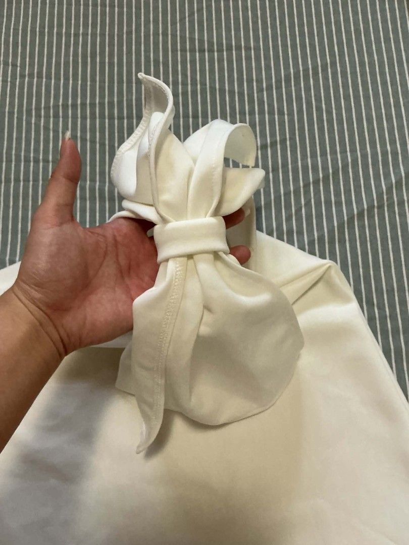 White One-Shoulder Top with Bow Detail (Category: Blouses) located in Quezon City. Submitted by dcltrrr8 (Listing ID 1451411890, Image 3). Description: - White one-shoulder top - Features a cute bow detail on the shoulder strap - Made from a soft, comfortable fabric - Perfect for dressing up or down - Easily pairs with skirts or pants.