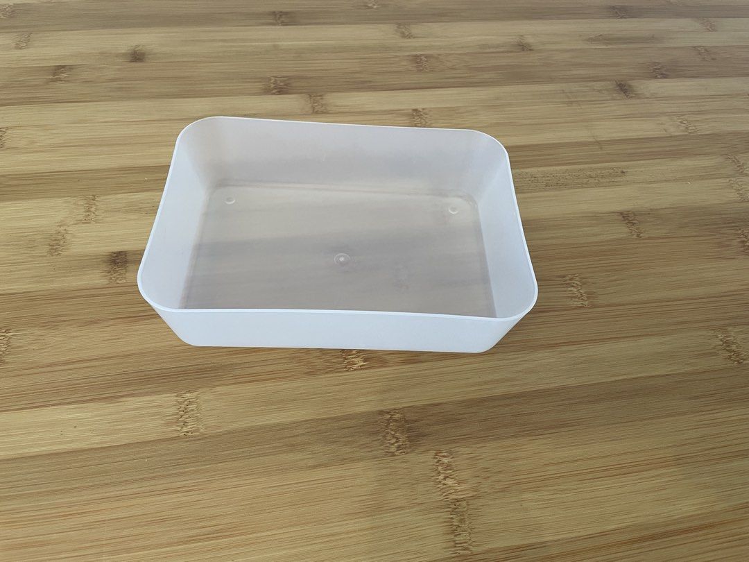 White rectangular plastic storage container (Category: Storage Boxes & Baskets) located in Singapore. Submitted by lgemc (Listing ID 1451411499, Image 1). Description: - Simple white plastic container - Rectangular shape with rounded corners - Translucent interior - Ideal for organizing small items - Easy to clean - Versatile for home or office - Dimensions: Approx. X x Y x Z cm.