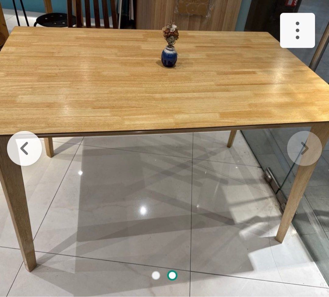 Solid Wood Dining Table (Category: Tables & Sets) located in Singapore. Submitted by vanillamangalica (Listing ID 1451429478, Image 1). Description: - Solid wood dining table - Natural wood grain finish - Seats 4 people comfortably - Ideal for small spaces & apartments - Sturdy, well-attached legs - Easy to clean surface - Selling due to relocation.