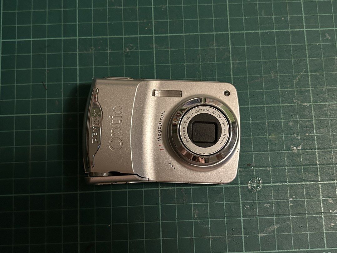 [WORKING] Digital Camera 📸 Pentax Optio E30 (Silver) (Category: Cameras) located in Manila. Submitted by gamityen (Listing ID 1451378765, Image 2). Description: - Pentax Optio E30 Digital Camera - 7.1 Megapixels - 3x Optical Zoom - Includes pink camera case - Battery NOT included - SD Card NOT included Bought for 3,900 Selling for 2,500 ⚠️ PLEASE READ BEFORE BUYING Condition: - Broken battery latch; can’t close properly (see photos) - Shutter wo
