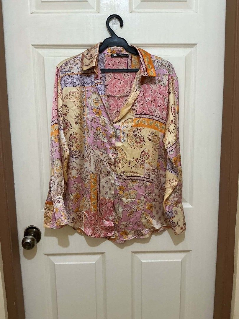 ZARA Patchwork Print Long Sleeve Shirt (Category: Tshirts & Polo Shirts ) located in Quezon City. Submitted by dcltrrr8 (Listing ID 1451411880, Image 2). Description: - ZARA shirt with a vibrant, colorful patchwork print. - Features long sleeves and a classic button-up design. - Made from a smooth, satin-like fabric. - Perfect for dressing up or down, offering great versatility. - Size Medium (M)..